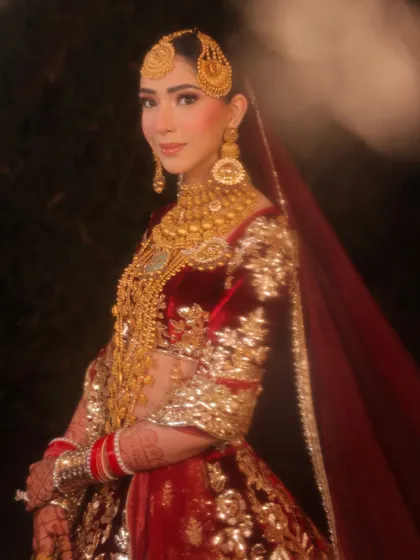 A portrait that captures the soul of this Kashmiri-inspired bridal look. The focus is on her expressive eyes, enhanced with subtle makeup, and the stunning traditional gold jewelry.