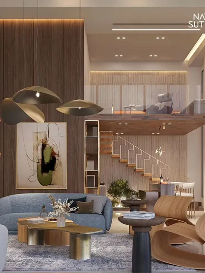 This view highlights the sculptural furniture and a floating mezzanine, demonstrating how we layer different functional zones within a single, cohesive space. The warm wood tones contrast beautifully with the cool concrete, a signature of our modernist designs.