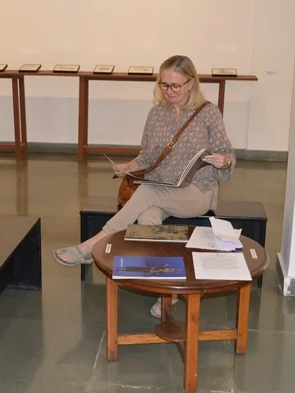 A visitor enjoying one of the books accompanying the 'Quieter than Silence' exhibition.