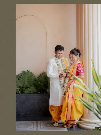 A quiet moment between the bride and groom during their Maharashtrian wedding ceremony, captured in a classic portrait style.