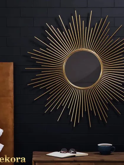 A classic golden sunburst mirror, also known as a starburst mirror. This timeless design adds a touch of mid-century modern glamour to any space, perfect above a dresser or in a living room.