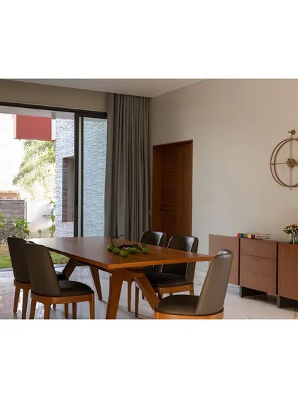 The dining space in the 'Solid Void Solid' house, positioned to overlook a landscaped court. This strategic placement ensures that daily activities are always connected to the outdoors, reinforcing a lifestyle that is in tune with nature.