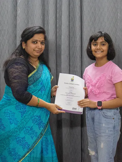 A student from our BEML branch receives her Trinity College exam certificate. I am committed to helping students achieve their goals.