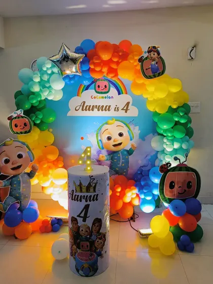 A vibrant Cocomelon theme with a rainbow balloon arch and multiple character standees, creating a fun and colorful atmosphere.