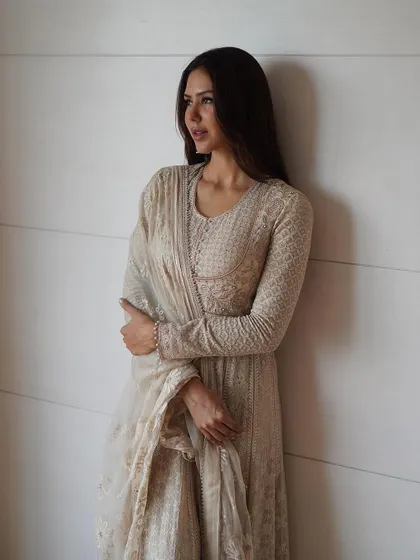 The timeless beauty of Chikankari. This profile shot of Sonam Bajwa highlights the delicate fabric and the classic elegance of the silhouette.
