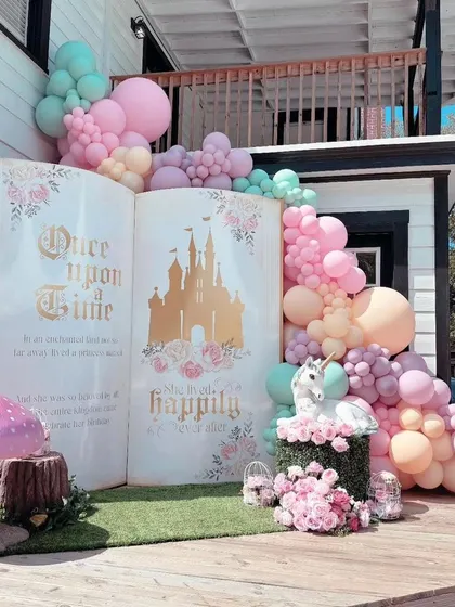 A "Once Upon a Time" storybook theme that opens a chapter to a fairytale world. This larger-than-life book backdrop, paired with pastel balloons and whimsical details, is perfect for birthdays or baby showers.
