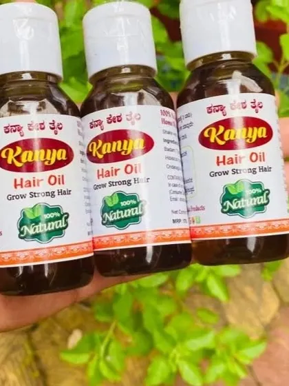 A close-up of three bottles, showing the rich color and handmade quality of the oil.
