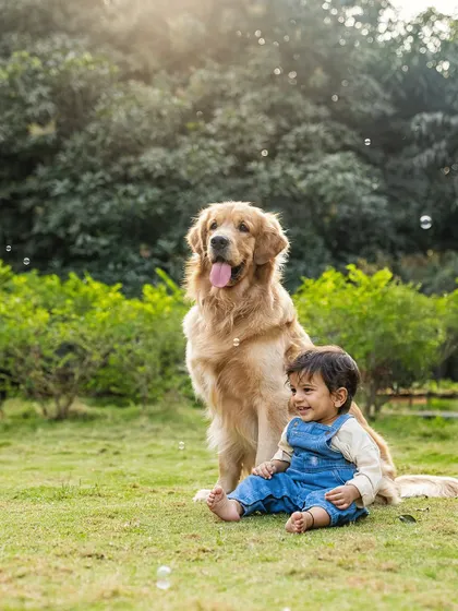 A beautiful portrait of Aariv and Ollie sitting together in the park. The bond between a child and their dog is something truly special to witness and capture.