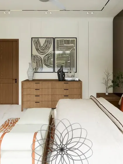 A view of the "Yūgen House" bedroom, showcasing its serene and simple aesthetic. The design focuses on clean lines, with a low-profile bed, a simple wooden dresser, and abstract art creating a tranquil atmosphere.