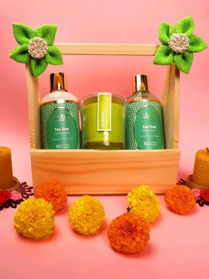 A tea tree shampoo and conditioner set styled with candles and flowers, creating a spa-like, relaxing vibe for the products.