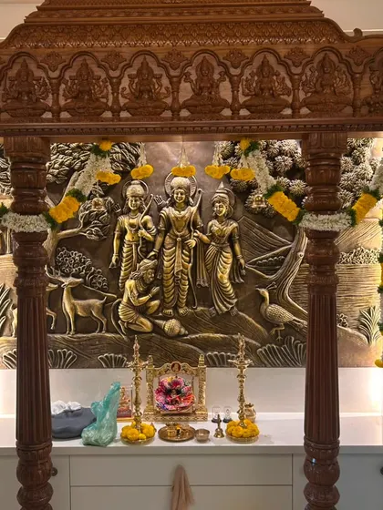 The lighting in this pooja space highlights the rich textures of the wooden mandap and the fresh flower decor. We aim to create a space that feels both grand and deeply spiritual.