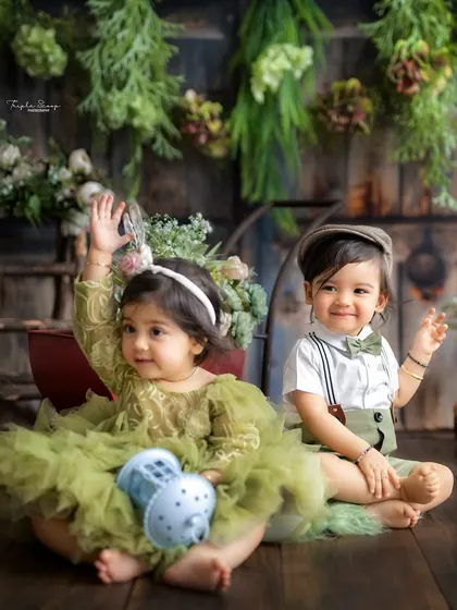 A fun shot of two little ones waving at the camera. I love capturing the interactions between babies during a shared session.