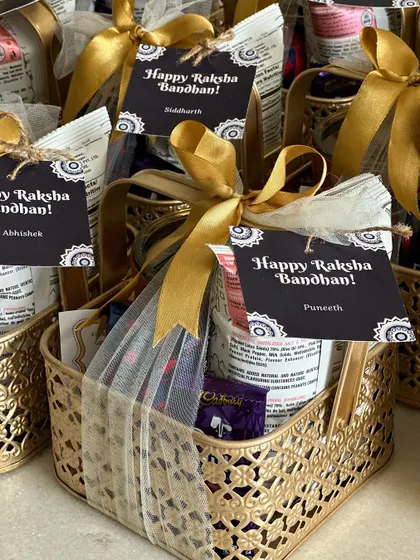 Another view of our popular Rakhi hampers, featuring personalized name tags for 'Siddharth' and 'Puneeth' to make the gift extra special for each brother.