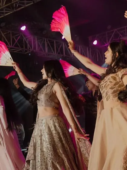 A beautifully coordinated bridesmaid performance using fans as props. This adds a unique visual element and a touch of elegance to the dance.