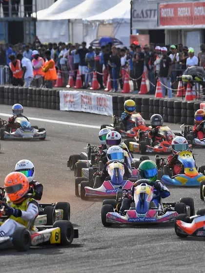 A full grid of karts streams through a corner at the CoASTT circuit. Our events attract large, competitive fields, making for spectacular racing.