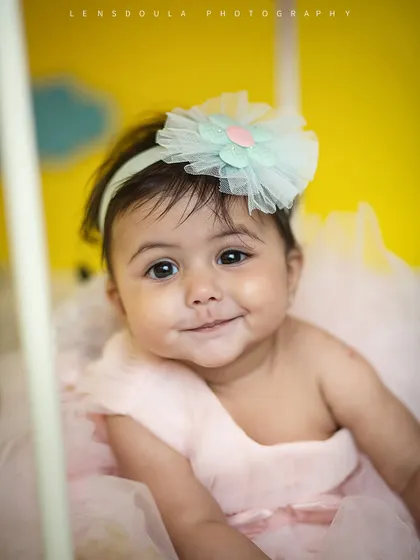 That little smirk is everything! We love capturing these fleeting expressions that showcase your baby's budding personality.