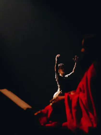 Another perspective on 'Mandala', showing the interplay between light, shadow, and the artists. The red of Chandana's saree is a vibrant counterpoint to my simple white costume.