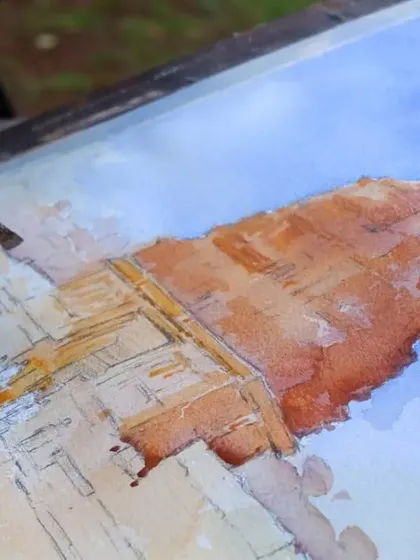 A work-in-progress shot of a watercolour landscape demonstration at the Kalakari 4 Festival in Satara, showing the initial layers of paint.