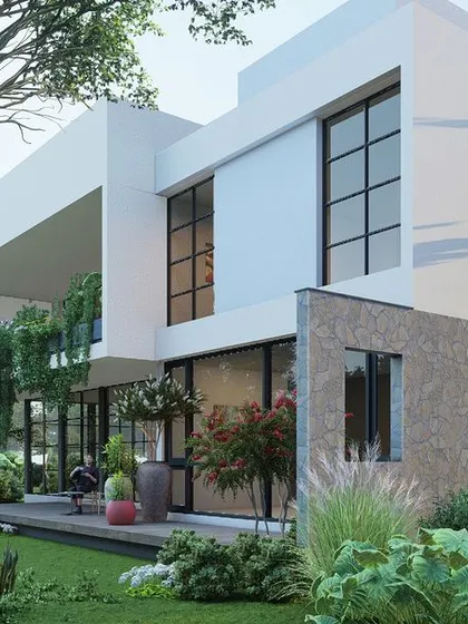 A different angle of the Hyderabad home, showcasing the use of textured stone on the lower level to add a rustic, natural element to the modern white structure.