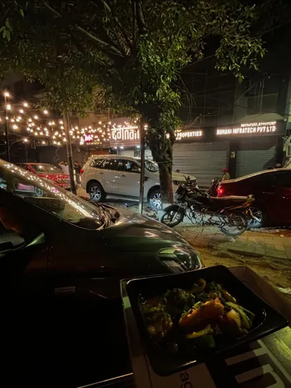 Another view of the 'Car-o-bar' setup, showcasing the convenience and enjoyment of a takeaway meal from Degnama.