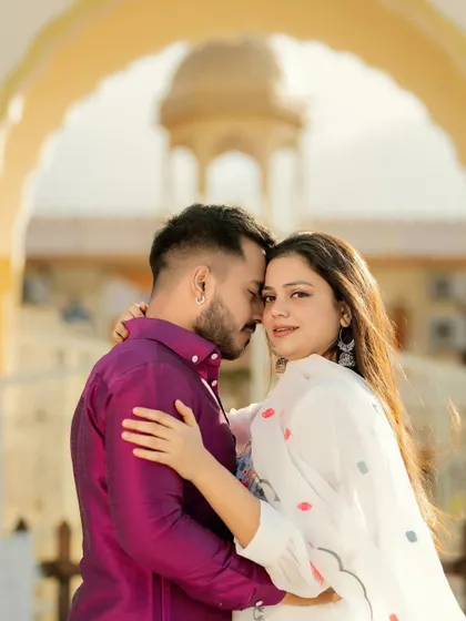 A close-up portrait of a couple in a loving embrace. The focus is on the bride's confident gaze and their strong connection, making for a powerful and intimate photograph.