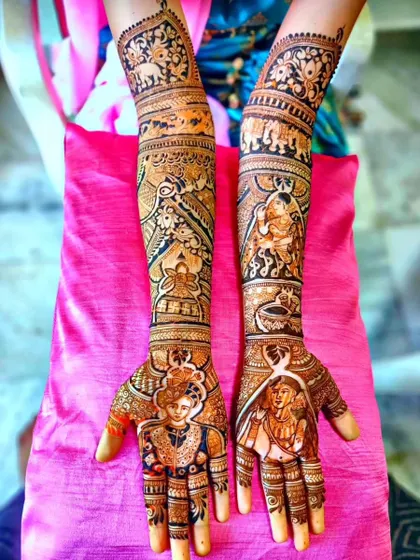 A multi-layered story mehendi with portraits. The design shows the couple on the palms, with other figures and traditional elephant motifs on the arms.