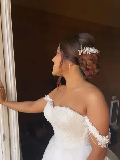 A side view of the bride's updo, adorned with a stunning, intricate hairpiece that adds a touch of sparkle.