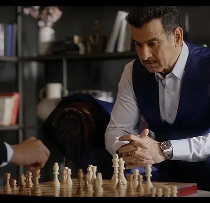 A still from the Sankalp Group commercial where Ronit Roy is contemplating his next move. The tailored waistcoat and crisp shirt create a classic, powerful look.