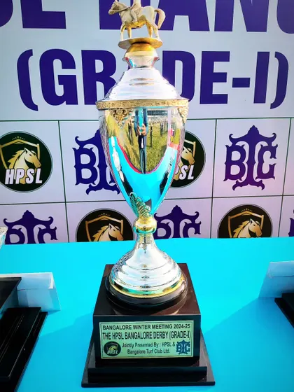 The HPSL Bangalore Derby trophy, a magnificent cup topped with a golden horse, signifying the pinnacle of racing achievement.