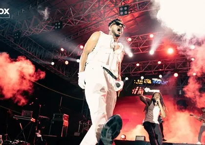 Another high-energy shot of King on stage, with red-tinted smoke adding to the dramatic effect.