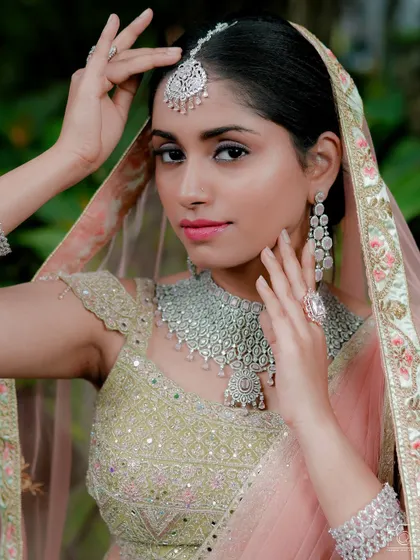 A beautiful shot of a bride in a modern AD choker and maang tikka. This look is perfect for a reception or engagement party.