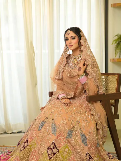 The full view of this elegant peach bridal look, showing how the makeup, hair, and outfit create a harmonious and graceful picture.