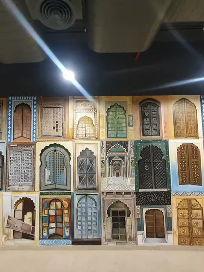 A straight-on shot of the 'Doorways of India' mural, showcasing the variety of colors, textures, and architectural styles depicted.
