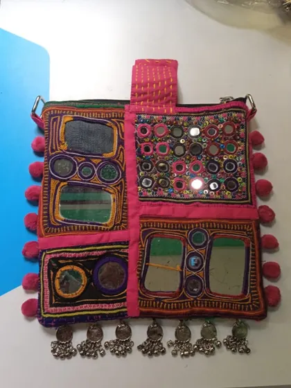 A close-up of the custom Kutch-inspired bag, a piece created from old and new elements, embodying our philosophy of personal and meaningful style.