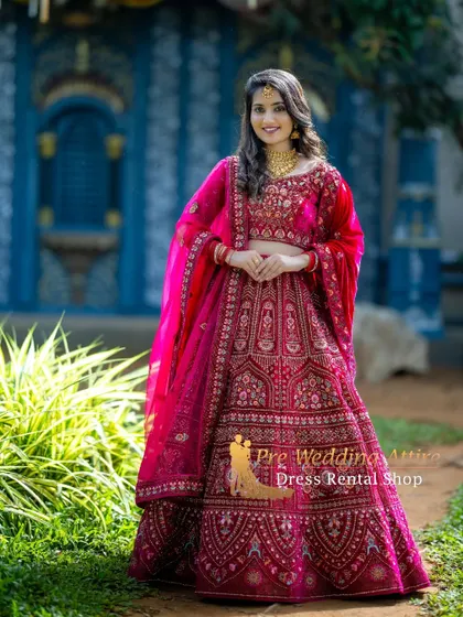 Another shot of the stunning pink and red lehenga, captured in a beautiful garden setting.