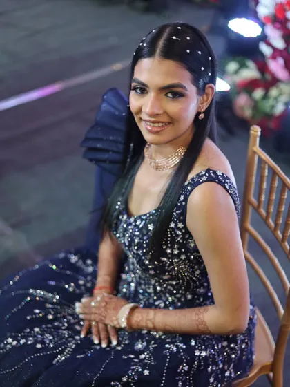 A dazzling bling makeup look for a reception. The eyes are the star of the show, with a dramatic smokey look and glitter.