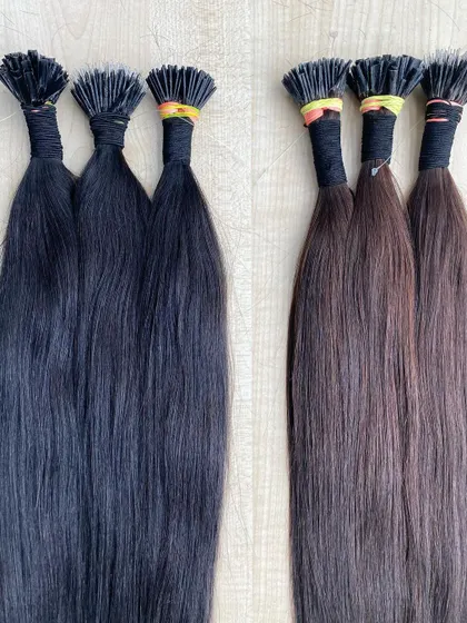 We offer I-Tip extensions in both natural black and dark brown. This image shows the subtle difference between the two shades, helping you choose the perfect match.