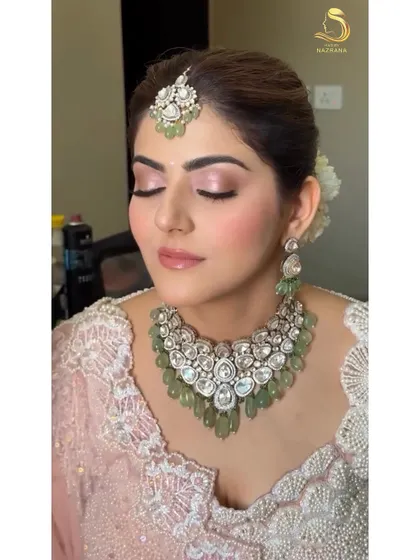 A beautiful portrait of the bride, with her soft makeup and the elegant textured bun just visible.