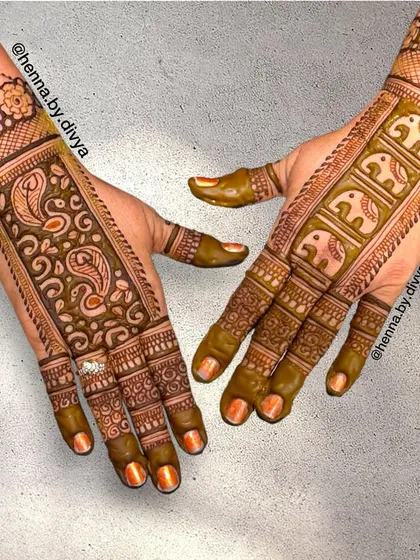 This back-hand design features a band of elephants and paisleys. It's a unique layout that leaves some skin showing while still feeling traditional and ornate.