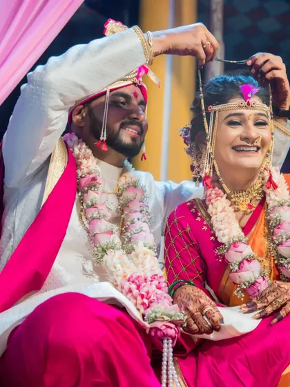 The groom places the mangalsutra around the bride's neck, a key moment of the wedding ceremony.