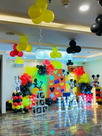 A wide view of the Mickey Mouse themed first birthday party for Ivan, showing the full extent of the decorations in the banquet hall.
