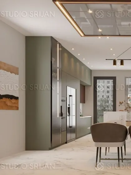 A view of the lobby and dining area in a Model Town home, showcasing sleek, olive-green cabinetry that extends from the kitchen into the living space.