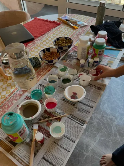 My painting setup at home for a mural project. It's usually a chaotic but happy mess of paints, brushes, and snacks.