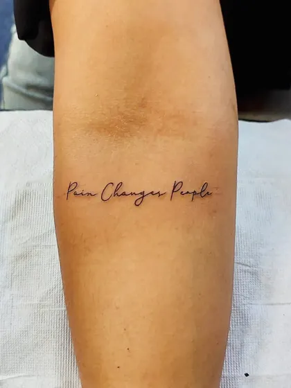 The quote "Pain Changes People" in a delicate, fine-line script. A powerful and personal motto to carry with you.