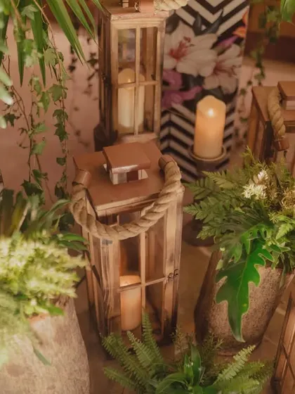 Rustic wooden lanterns with candles, adding a warm and inviting glow to the tropical decor.