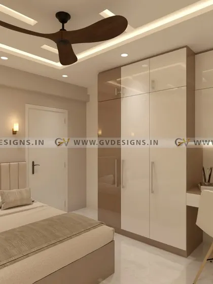 We designed this bedroom with a swing wardrobe that has a seamlessly integrated study unit. The acrylic finish provides a contemporary elegance, while spotlights in the open shelves and a strip light below add a captivating glow.