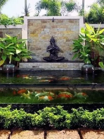 We bring tranquility to your doorstep with custom aquatic features. This serene pond, complete with a calming Buddha statue and thriving plants, is designed to be a focal point of peace and natural beauty in your garden.