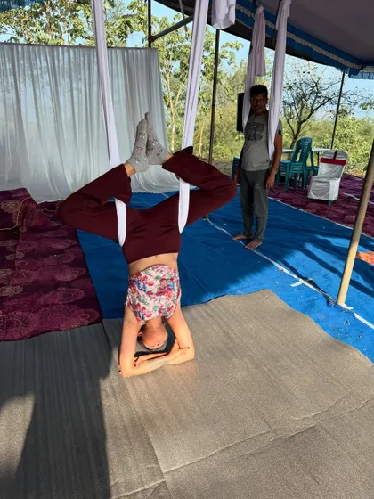 A throwback to an aerial yoga workshop in Attapadi, Kerala. Here, a participant is supported by the silk in a forearm headstand, building confidence in inversions.