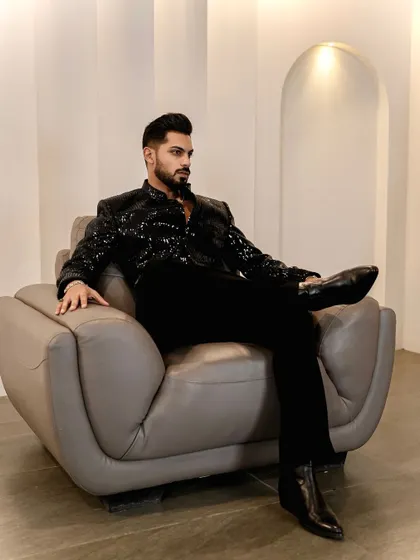 A confident, relaxed pose in our black sequined Indo-Western jacket. Paired with sleek black trousers and boots, it's a head-to-toe look of modern elegance.