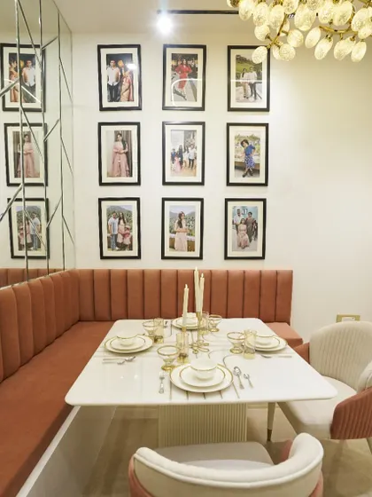 The gallery wall is the heart of this dining space, turning a simple wall into a collection of cherished memories.